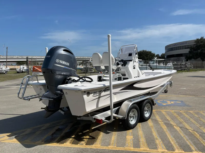 Slide: The Image of 2023 Blue Wave 2200 STL boat on a trailer with Yamaha outboard motor. - 5