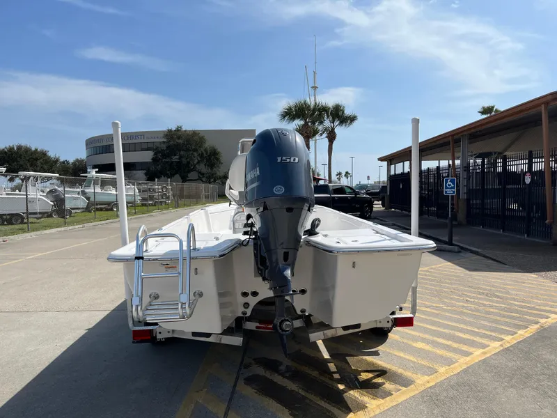 Slide: The Image of 2023 Blue Wave 2200 STL boat with Yamaha 150 engine, rear view at marina. - 6