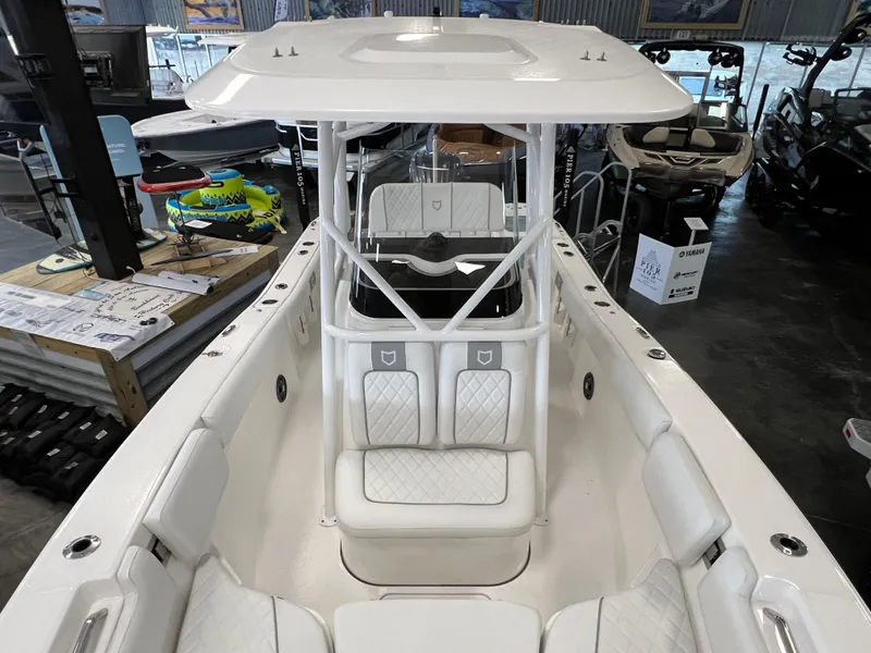 Slide: The Image of 2024 Sea Fox 228 Commander boat interior with white seating and T-top. - 10