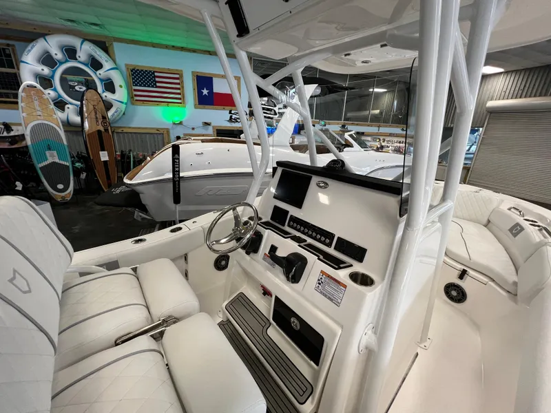 Slide: The Image of 2024 Sea Fox 228 Commander boat interior with steering console and seating. - 12