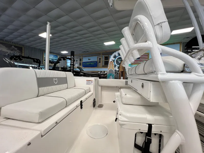 Slide: The Image of 2024 Sea Fox 228 Commander boat interior with white seating and storage compartments. - 14