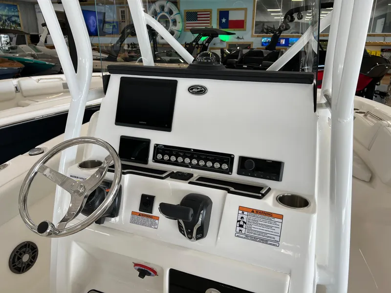 Slide: The Image of 2024 Sea Fox 228 Commander boat console with steering wheel and electronic controls. - 4