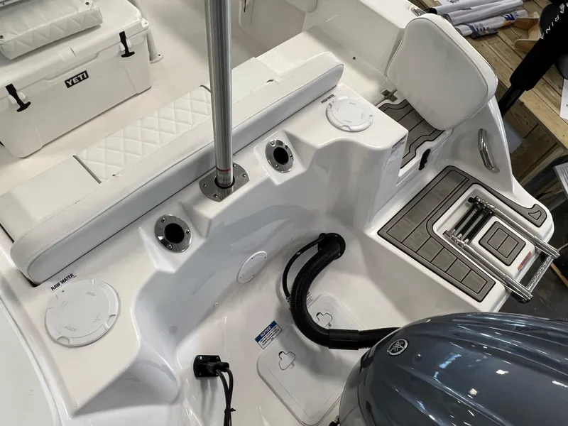 Slide: The Image of 2024 Sea Fox 228 Commander boat interior with seating, motor, and storage compartments. - 7