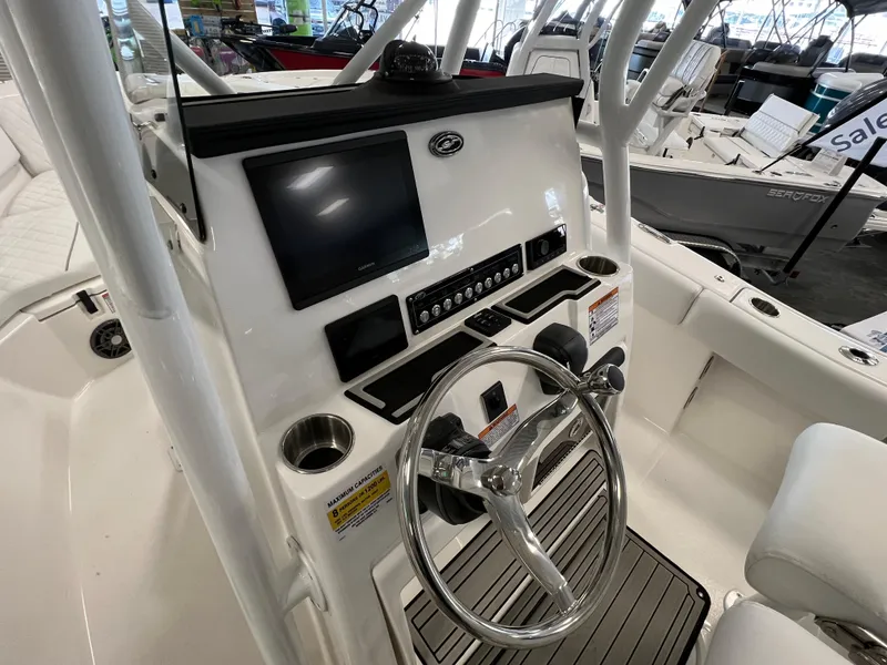 Slide: The Image of 2024 Sea Fox 228 Commander boat console with steering wheel and electronic display. - 9