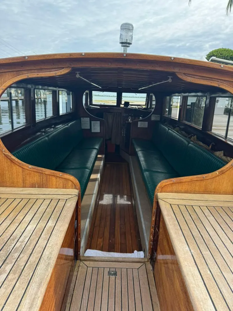 Slide: The Image of Interior view of a 1994 Grand Craft 37 boat with wooden finish and green seating. - 2