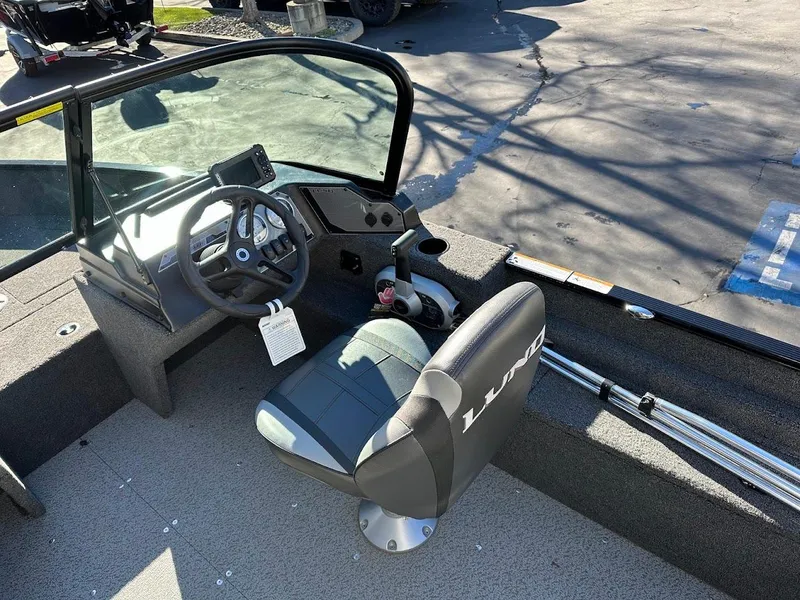 Slide: The Image of 2024 Lund 1650 Angler Sport boat interior with steering console and seating. - 14