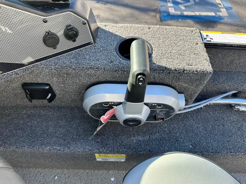Slide: The Image of 2024 Lund 1650 Angler Sport boat throttle control on carpeted console. - 19