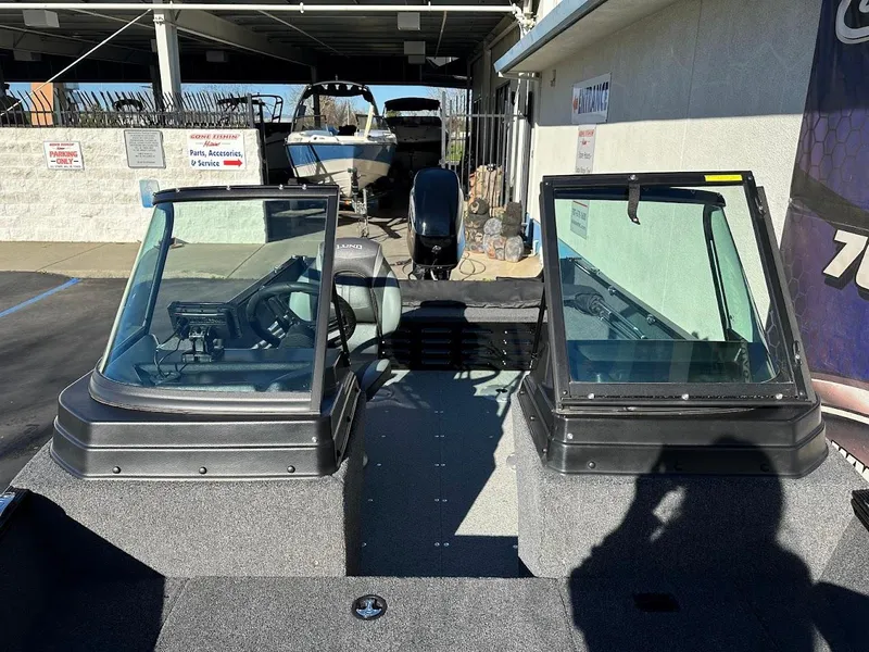 Slide: The Image of 2024 Lund 1650 Angler Sport boat with dual windshields in a showroom. - 25