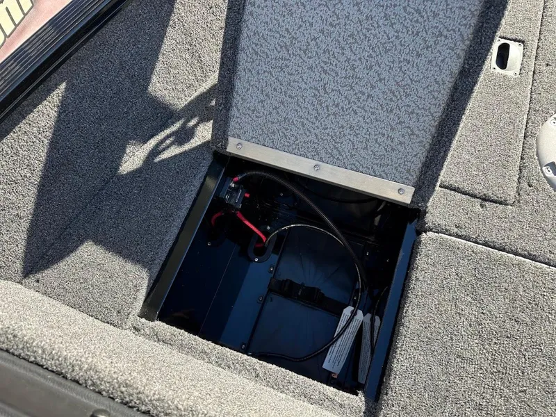 Slide: The Image of 2024 Lund 1650 Angler Sport boat battery compartment with open hatch. - 28