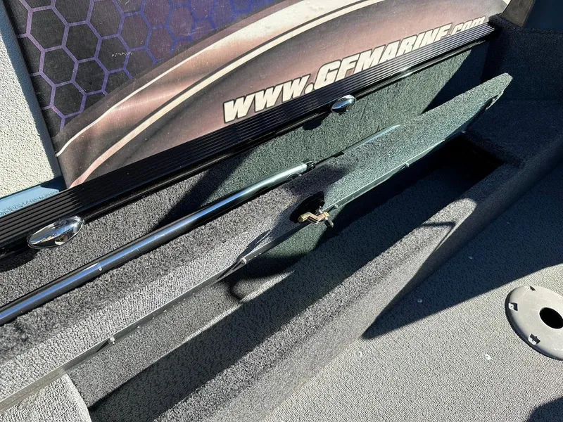 Slide: The Image of 2024 Lund 1650 Angler Sport boat interior with rod storage compartment. - 29