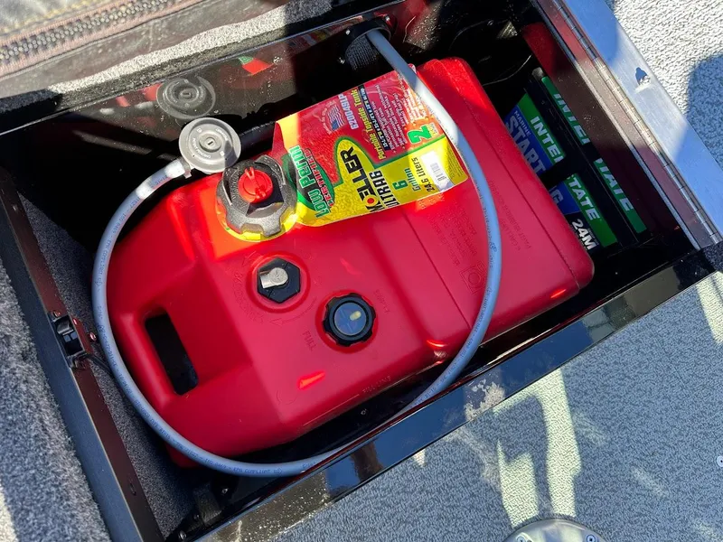 Slide: The Image of Red fuel tank in 2024 Lund 1650 Angler Sport boat compartment. - 31