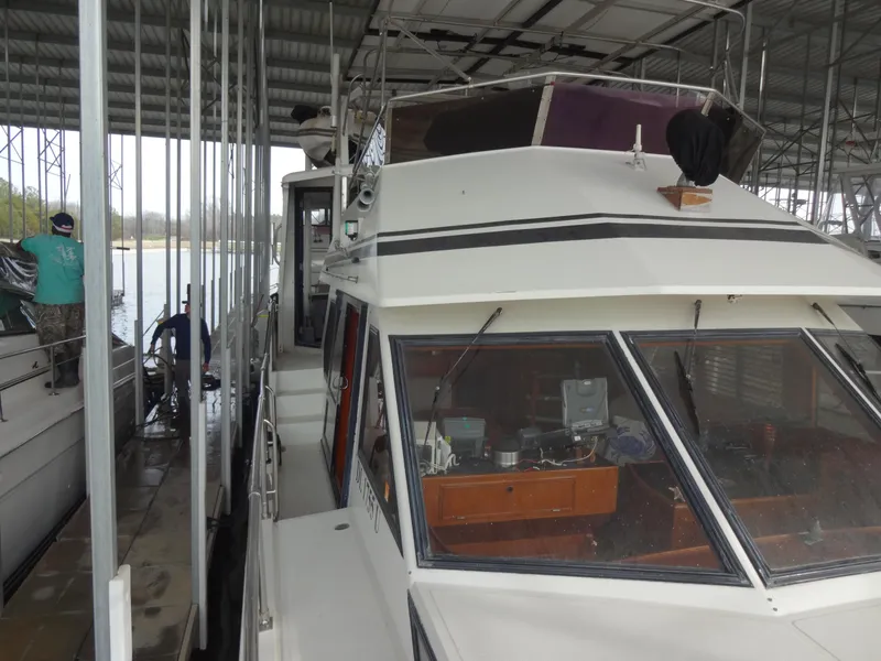 Slide: The Image of 1989 Hi-Star AFT Cabin Sundeck Motor Yacht docked in a covered marina. - 10