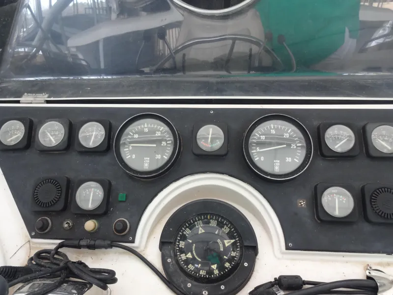 Slide: The Image of 1989 Hi-Star AFT Cabin Sundeck Motor Yacht control panel with gauges and compass. - 13