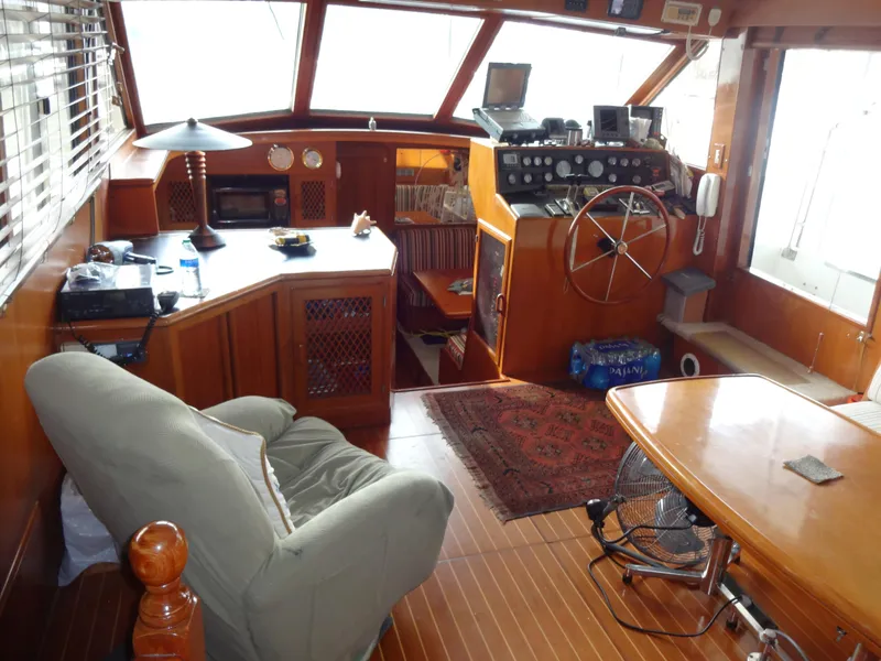 Slide: The Image of Interior of 1989 Hi-Star AFT Cabin Sundeck Motor Yacht with wooden furnishings and steering wheel. - 18
