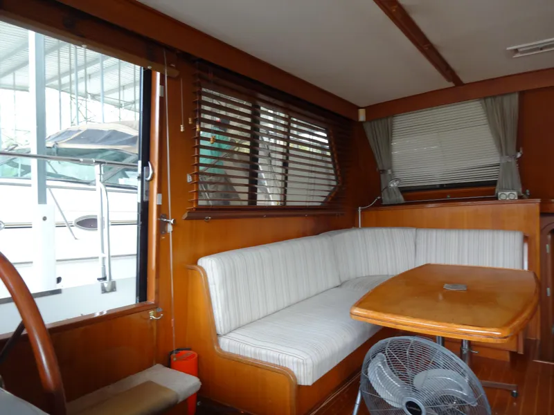 Slide: The Image of Interior of 1989 Hi-Star AFT Cabin Sundeck Motor Yacht with wood paneling and seating area. - 19