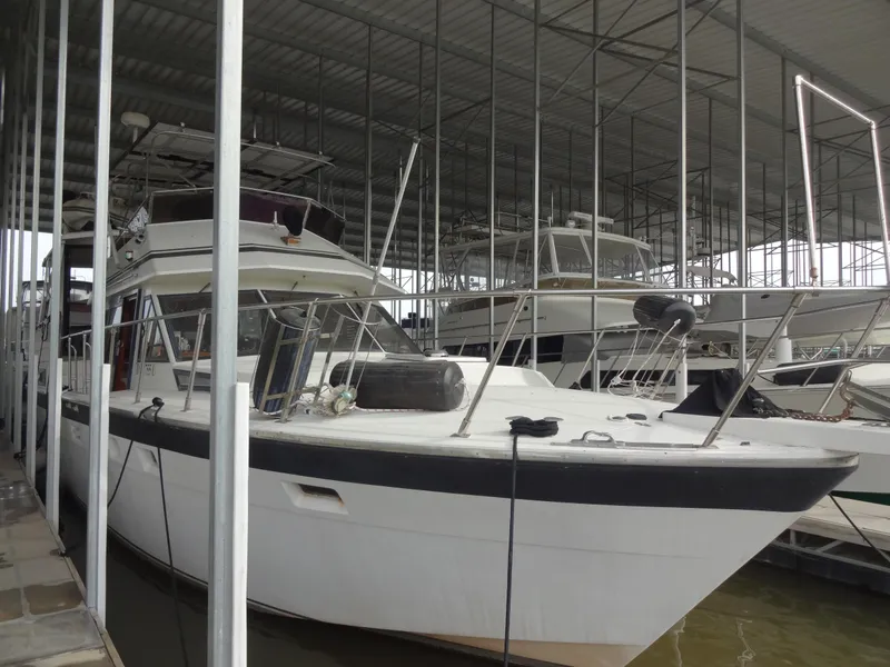 Slide: The Image of 1989 Hi-Star AFT Cabin Sundeck Motor Yacht docked in a covered marina. - 2