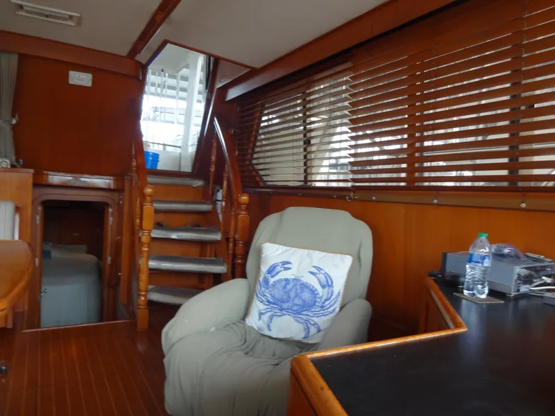 Slide: The Image of Interior of 1989 Hi-Star AFT Cabin Sundeck Motor Yacht with wooden paneling and cozy seating. - 20
