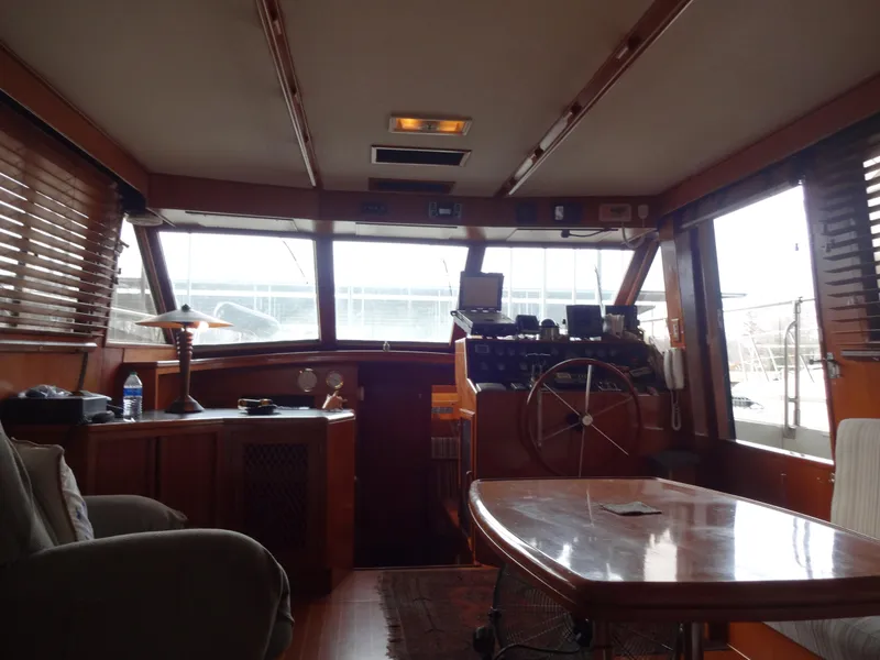 Slide: The Image of Interior of 1989 Hi-Star AFT Cabin Sundeck Motor Yacht with wooden furnishings and steering wheel. - 21