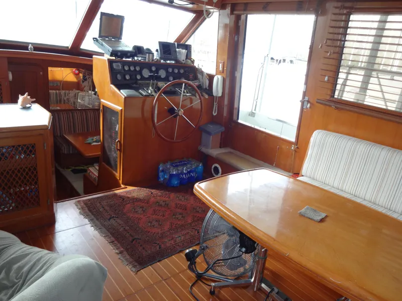Slide: The Image of 1989 Hi-Star AFT Cabin Sundeck Motor Yacht interior with helm, seating, and wooden decor. - 23