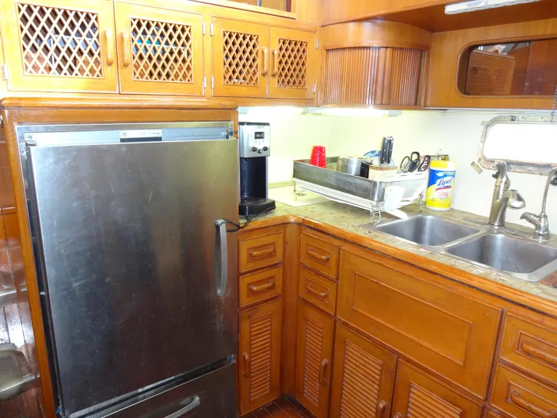 Slide: The Image of 1989 Hi-Star AFT Cabin Sundeck Motor Yacht kitchen with wooden cabinets and stainless steel appliances. - 26