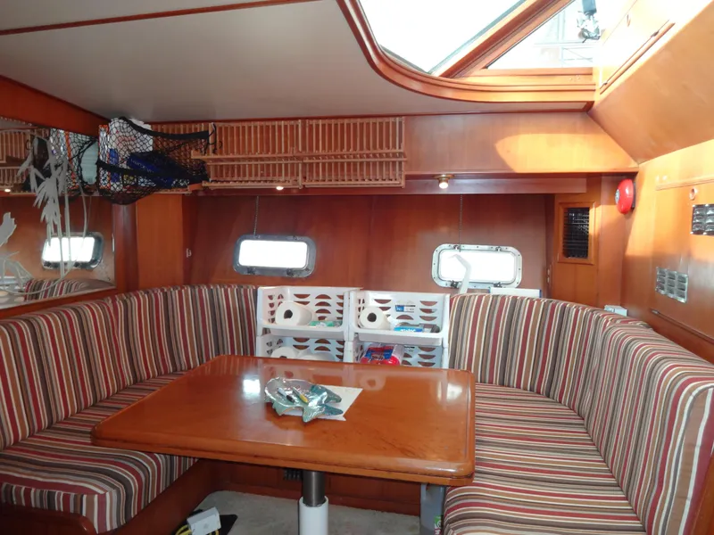 Slide: The Image of Interior of 1989 Hi-Star AFT Cabin Sundeck Motor Yacht with striped seating and wooden table. - 27