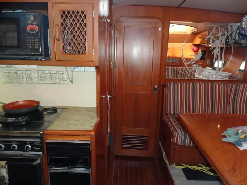 Slide: The Image of 1989 Hi-Star AFT Cabin Sundeck Motor Yacht interior with kitchen and dining area. - 28