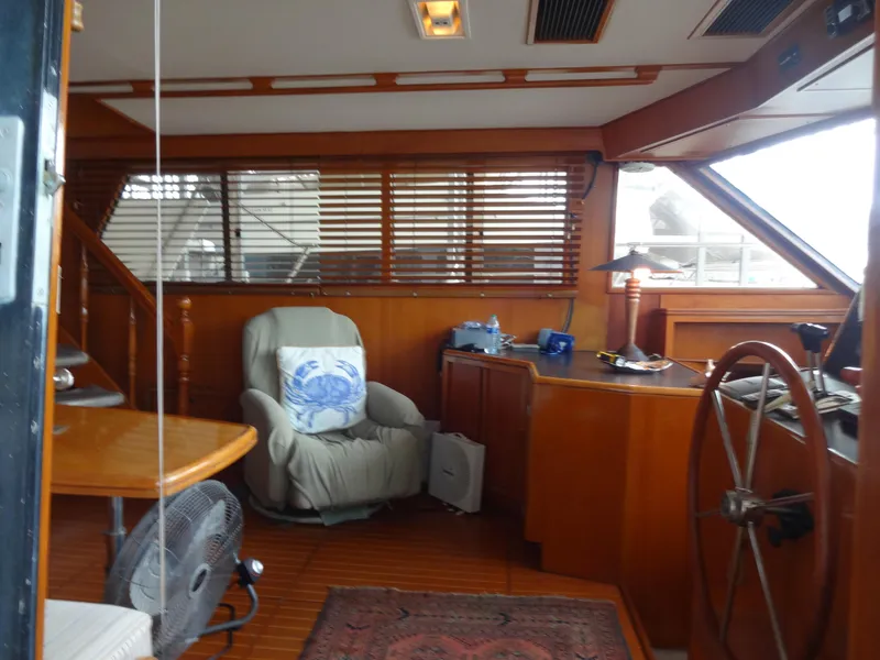Slide: The Image of 1989 Hi-Star AFT Cabin Sundeck Motor Yacht interior with wooden decor and steering wheel. - 3