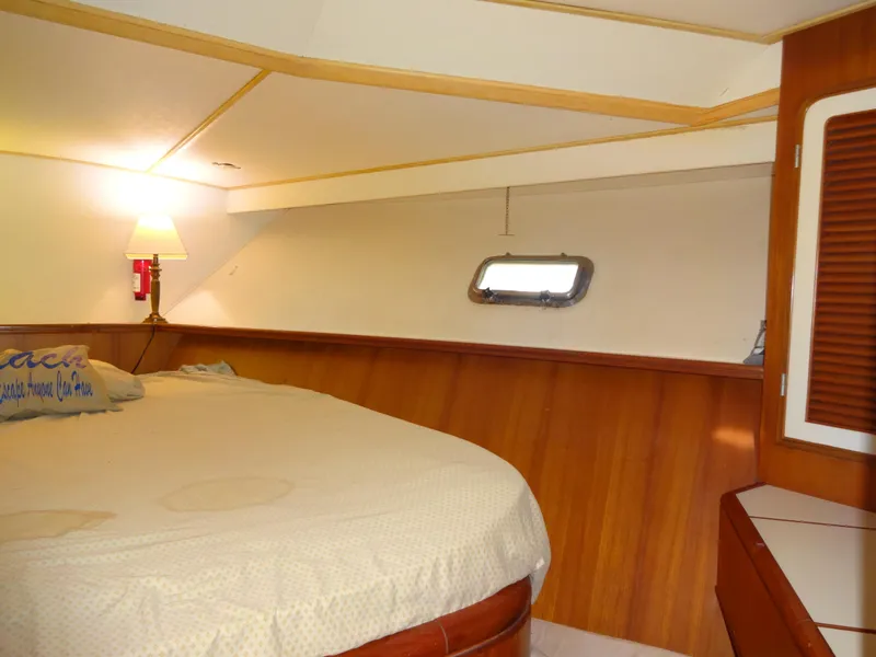 Slide: The Image of Cozy cabin interior of 1989 Hi-Star AFT Cabin Sundeck Motor Yacht with bed and porthole. - 30