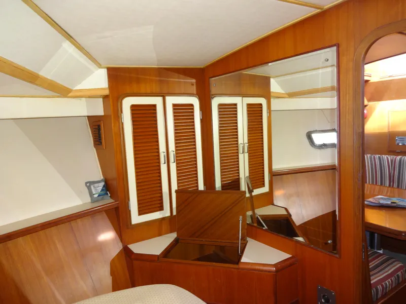 Slide: The Image of 1989 Hi-Star AFT Cabin Sundeck Motor Yacht interior with wood paneling and mirrored closet. - 32