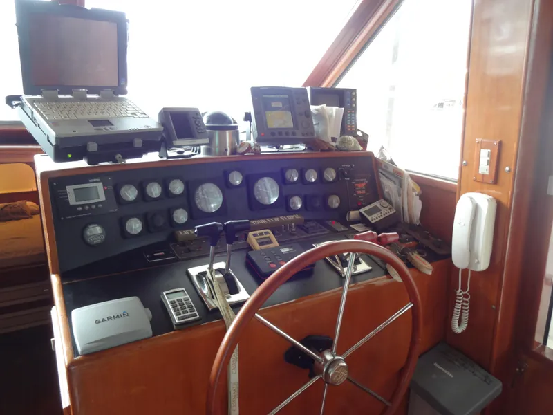 Slide: The Image of 1989 Hi-Star AFT Cabin Sundeck Motor Yacht helm with navigation equipment and steering wheel. - 36
