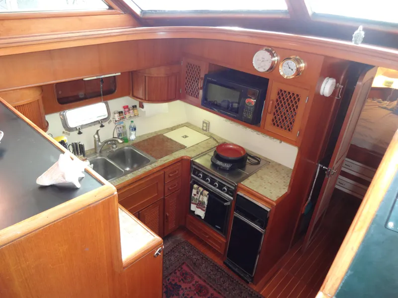 Slide: The Image of 1989 Hi-Star AFT CABIN SUNDECK MOTOR YACHT kitchen with wood cabinetry and modern appliances. - 37