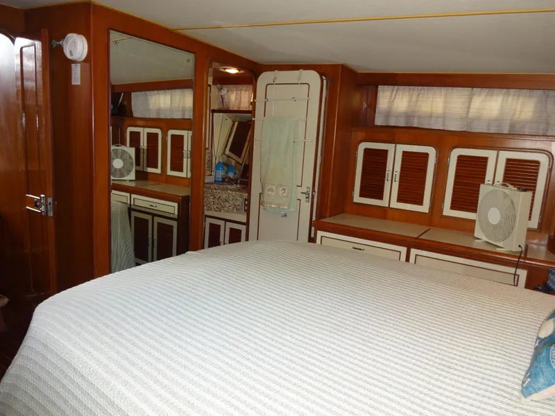 Slide: The Image of 1989 Hi-Star AFT Cabin Sundeck Motor Yacht interior with wood cabinetry and bed. - 40