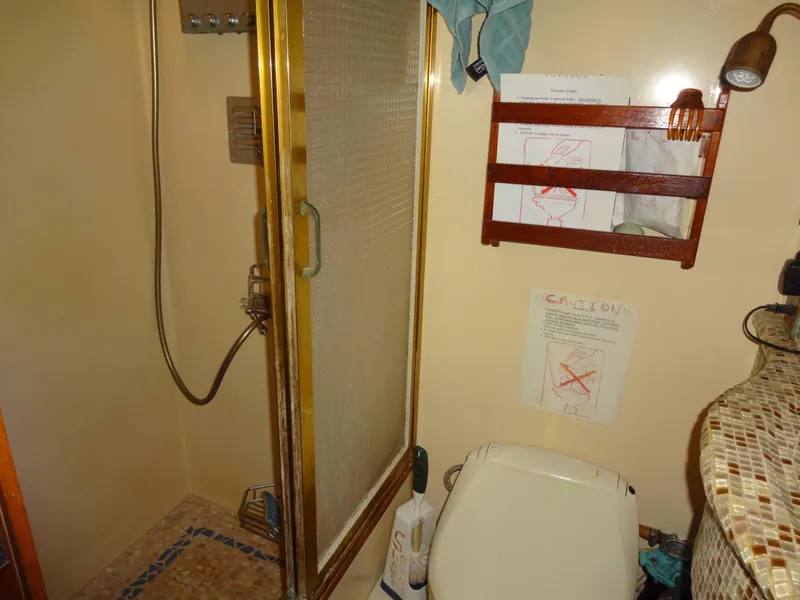 Slide: The Image of 1989 Hi-Star yacht bathroom with shower, toilet, and tiled countertop. - 44