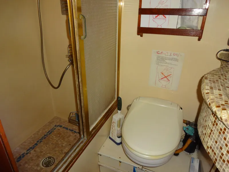 Slide: The Image of 1989 Hi-Star yacht bathroom with shower, toilet, and mosaic sink. - 45