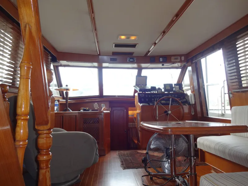 Slide: The Image of Interior of 1989 Hi-Star AFT Cabin Sundeck Motor Yacht with wooden furnishings and helm. - 49
