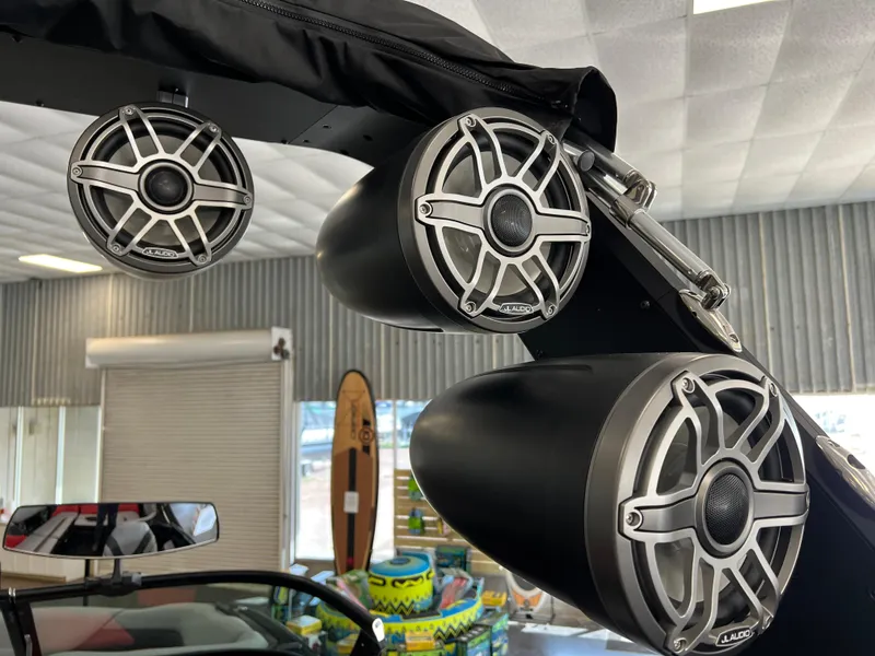 Slide: The Image of 2024 MB B52 boat speakers mounted on a wakeboard tower in a showroom. - 11