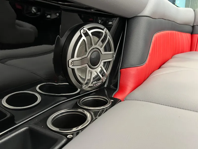 Slide: The Image of 2024 MB B52 interior with speaker and cup holders, featuring red and gray upholstery. - 5