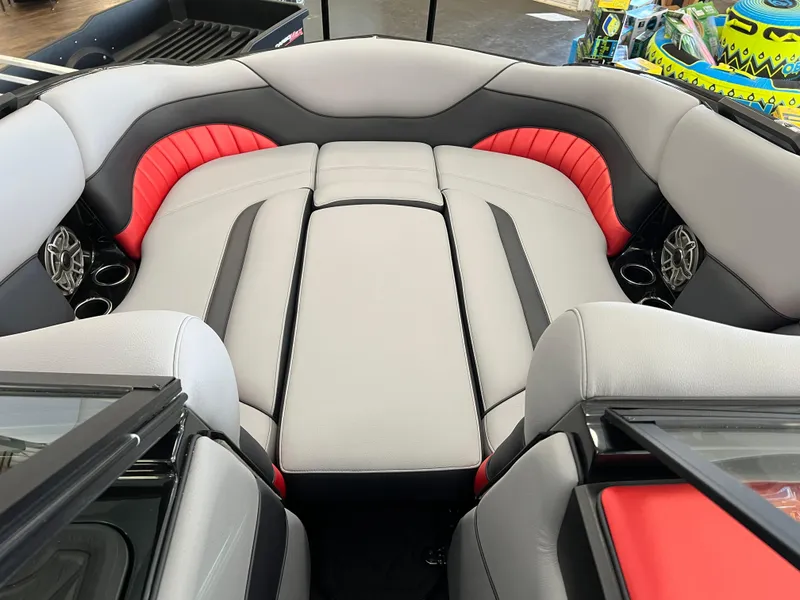 Slide: The Image of 2024 MB B52 boat interior with gray and red seating, cup holders, and sleek design. - 8