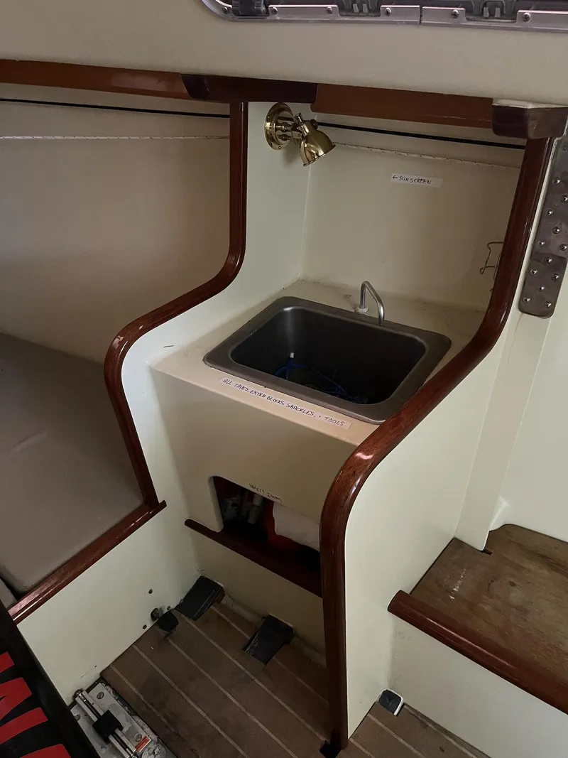 Slide: The Image of 2007 Custom Hallett 33 boat interior with sink and wooden trim. - 10