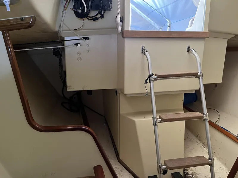 Slide: The Image of Interior of a 2007 Custom Hallett 33 boat with ladder and control panel. - 12