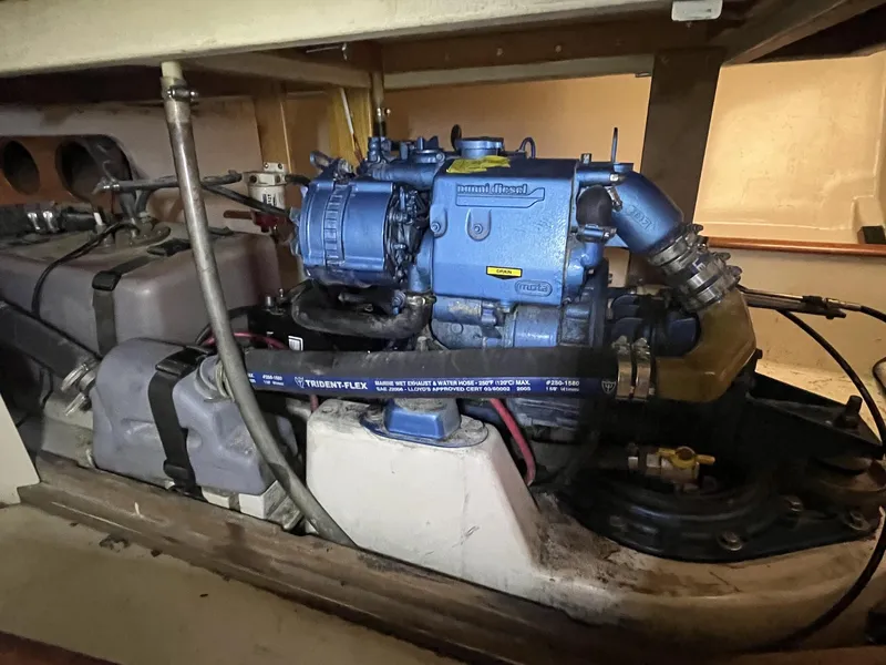 Slide: The Image of Engine compartment of a 2007 Custom Hallett 33 boat with a blue marine engine. - 14