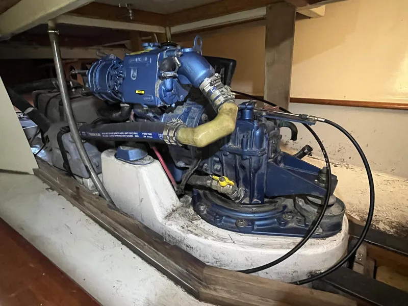 Slide: The Image of Engine compartment of a 2007 Custom Hallett 33 boat with blue engine components. - 15