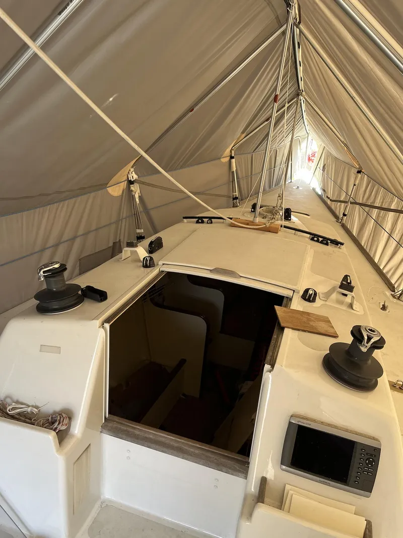 Slide: The Image of 2007 Custom Hallett 33 sailboat interior under a protective cover. - 19