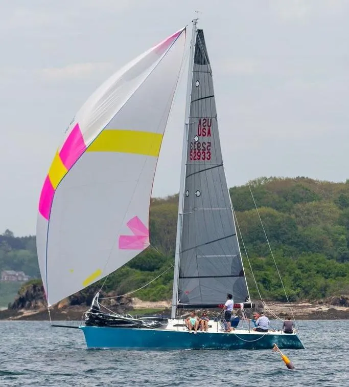 Slide: The Image of Sailing a 2007 Custom Hallett 33 boat with colorful spinnaker on a calm sea. - 2