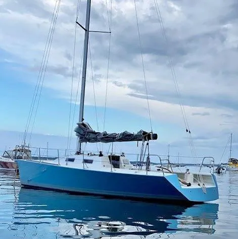Slide: The Image of 2007 Custom Hallett 33 sailboat on calm water under cloudy sky. - 5