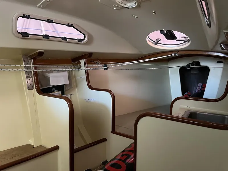Slide: The Image of Interior of a 2007 Custom Hallett 33 boat with wooden trim and portholes. - 9