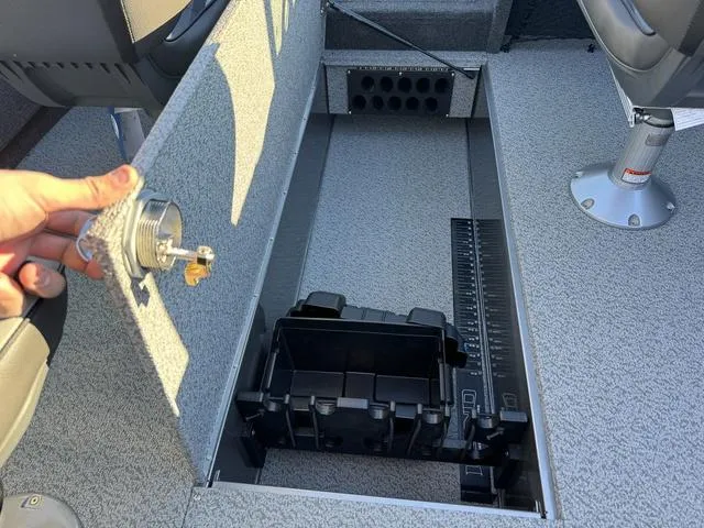 Slide: The Image of 2024 Lund 1975 Tyee Sport boat interior with storage compartment open. - 10