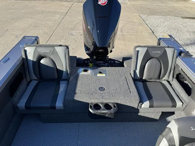 Slide: The Image of 2024 Lund 1975 Tyee Sport boat interior with seating and motor. - 15