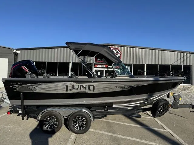 Slide: The Image of 2024 Lund 1975 Tyee Sport boat on trailer, parked outside dealership. - 16