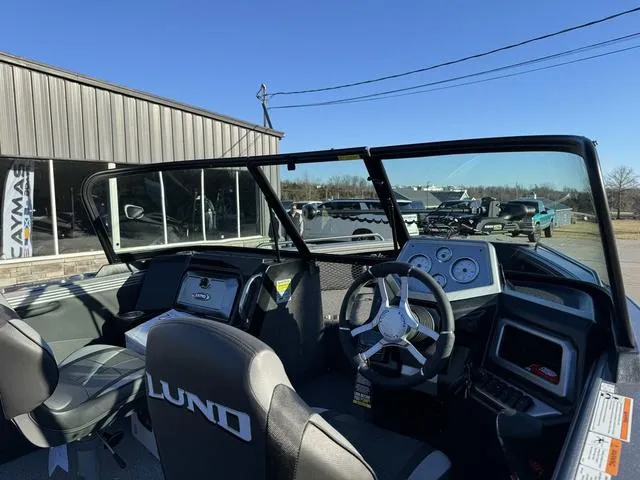 Slide: The Image of 2024 Lund 1975 Tyee Sport boat interior with steering wheel and dashboard. - 4